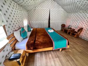 a bedroom with a large bed in a room at North Deodar Camps in Kasol