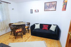 a living room with a couch and a table at Old Fashion Guest House in Soko Banja