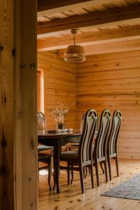 a dining room with a table and chairs at Vila Juodenėnai in Žaugėdai