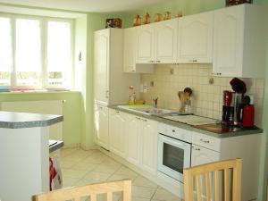 a kitchen with white cabinets and a counter top at Maison de 4 chambres avec terrasse amenagee a Valuejols 