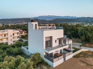 a house on a hill with a view at Soleado Villa Chania (rooftop pool) in Chania Town