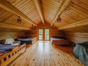 a room with three beds in a log cabin at Vila Juodenėnai in Žaugėdai