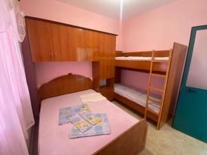 a small room with a bed and bunk beds at DRINI in Velipojë