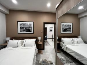 Una cama o camas en una habitación de DREAMFIELD NEST at SKYNEST APARTMENTS