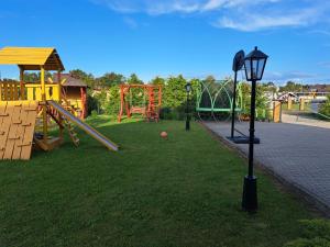a park with a playground with a slide at Mobilūs nameliai 'Zelma' in Palanga