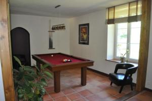 a living room with a pool table in it at Moulin Chantepierre in Pont-dʼHéry