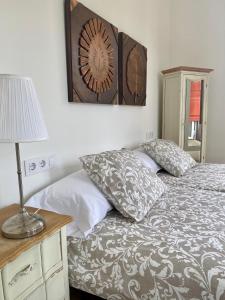 a bedroom with a bed and a lamp on a table at El Balcón del Eume, Cantina Río Covés in Puentedeume