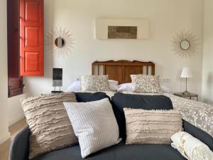 a bedroom with a bed with two pillows on it at El Balcón del Eume, Cantina Río Covés in Puentedeume