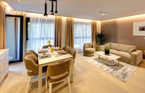 a living room with a table and chairs and a couch at Four Blue Seasons - Luxury Apartments Dubrovnik in Dubrovnik