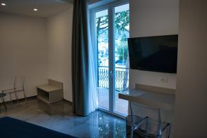 a room with a large sliding glass door to a balcony at WeRooms in Salerno