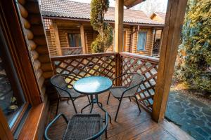 a patio with chairs and a table on a deck at Villa Garden Hotel in Solochyn