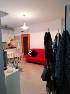 sala de estar con sofá rojo y cocina en LaMagnolia en Fossacesia
