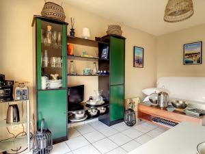 a kitchen with green shelving in a room at Appartement Crozon, 3 pièces, 4 personnes - FR-1-370-68 in Crozon