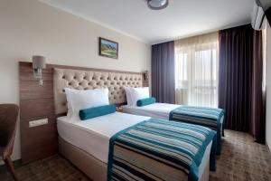 a hotel room with two beds and a window at Hotel Cherno More in Varna City +46 photos