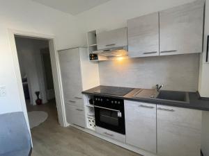 a kitchen with a sink and a stove top oven at Fewo ToNi in Wismar +2 photos