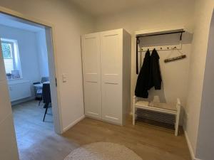 a room with a closet and a door with a coat at Fewo ToNi in Wismar