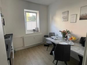 a kitchen and dining room with a table and a window at Fewo ToNi in Wismar