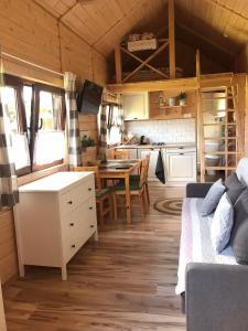 a kitchen and living room in a tiny house at Arena White Houses in Okuninka +20 photos