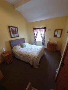 a bedroom with a bed and a window at Slane Farm Hostel, Cottages and Camping in Slane