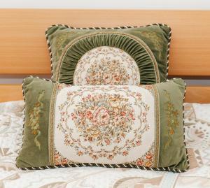 a pile of pillows sitting on top of a bed at Wilena Apartments in Piran
