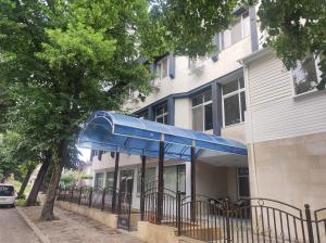 a blue canopy in front of a building at КИАНТИ in Kŭrdzhali