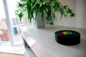 a vinyl record sitting on a white table with a vase at Chichele House, sleeps 8, allocated parking, pets, free wi-fi, corporate welcome in Higham Ferrers