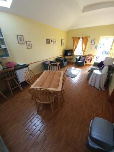 a living room with a wooden table and chairs at Slane Farm Hostel, Cottages and Camping in Slane