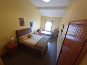 a bedroom with two beds and a window at Slane Farm Hostel, Cottages and Camping in Slane