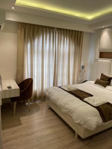 a hotel room with a bed and a desk and a bedroom at Palmo Holiday Apartments in Kathmandu