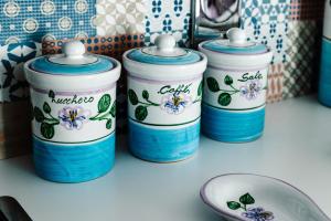 a group of blue and white containers on a counter at Le Isole di Anita in Lipari