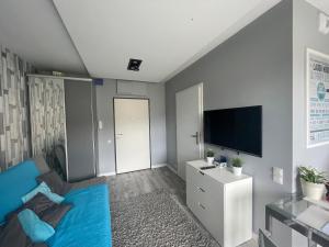 Televízia a/alebo spoločenská miestnosť v ubytovaní Apartamenty Horyzont SeaView by Rent like home