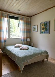 a bedroom with a bed in a room with a window at Talo Valoisa in Rovaniemi