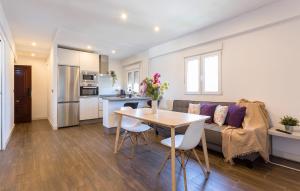 a kitchen and living room with a table and a couch at San Jose 2 baños in Cádiz