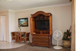 uma sala de estar com uma televisão e uma mesa em Maalaea Kai Resort 213 em Wailuku