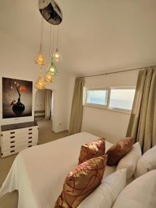 a bedroom with a white bed and a couch at Villa Bella in Torre delle Stelle