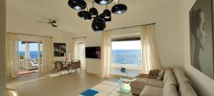 a living room with a couch and a view of the ocean at Villa Bella in Torre delle Stelle