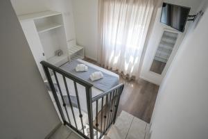 a staircase with two towels on a table in a room at Rimini Bay Suites&Residence in Rimini