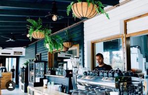 a man sitting at a counter in a restaurant at Tweed River Retreat in Tweed Heads