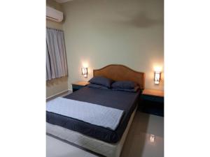 a bedroom with a bed with two night stands and two lamps at Unit B-801 SERI BULAN CONDO HOME SWEET HOME in Port Dickson +19 photos