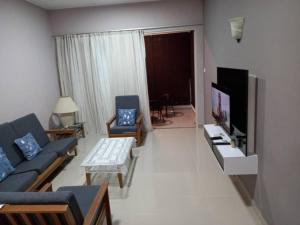 a living room with a couch and a tv at Unit B-801 SERI BULAN CONDO HOME SWEET HOME in Port Dickson