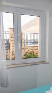 a window in a room with a view of a building at Adria Apartment in Hvar
