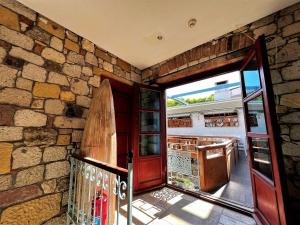 a room with a door and a surfboard on a wall at KEYİFTE Alaçatı in Alacati +23 photos