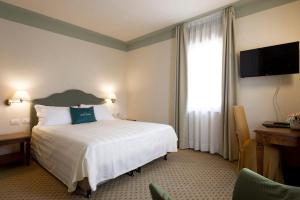 Posteľ alebo postele v izbe v ubytovaní Cora Hotels Leon d'Oro
