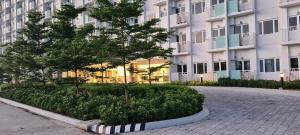 a large apartment building with a tree in front of it at Paranaque SM-Sucat Field Res. Bldg 5, 2/F, 2BR with Balcony in Manila