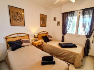 Łóżko lub łóżka w pokoju w obiekcie AVANOA - Esmeralda Calpe