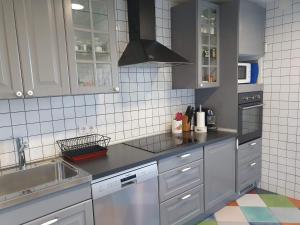 a kitchen with white cabinets and a sink at Las Mejores VISTAS de SALAMANCA!!! in Salamanca