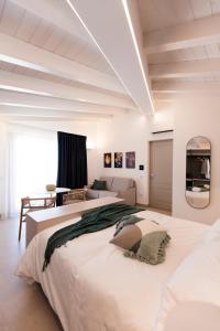 a bedroom with two beds and a couch at NITI Palace in Castellammare del Golfo
