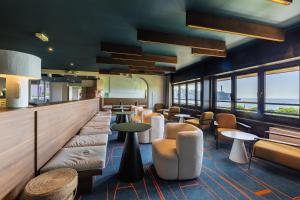 a restaurant with chairs and tables and windows at Belambra Clubs Anglet - La Chambre d'Amour in Anglet
