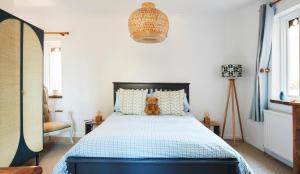 a bedroom with a bed with a teddy bear on it at Refurbished Seaside Retreat in the Heart of Cromer in Cromer