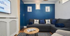 a living room with a couch and a table at Refurbished Seaside Retreat in the Heart of Cromer in Cromer